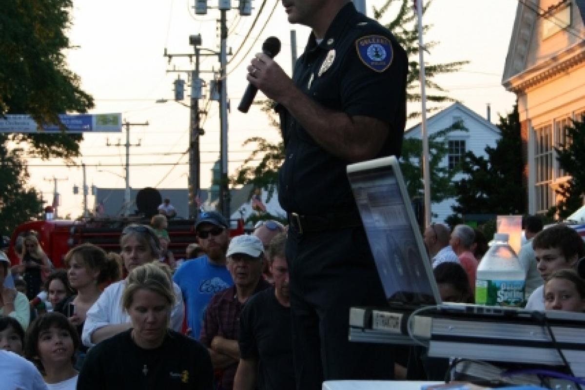A police officer speaking to the crowd 2